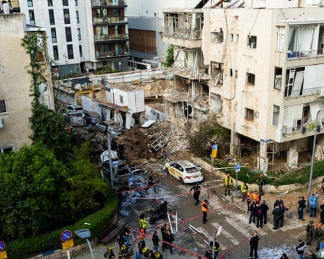 Security and rescue personnel next to a building destroyed by a missile in Tel Aviv Security and rescue personnel next to a building destroyed by a missile in Tel Aviv