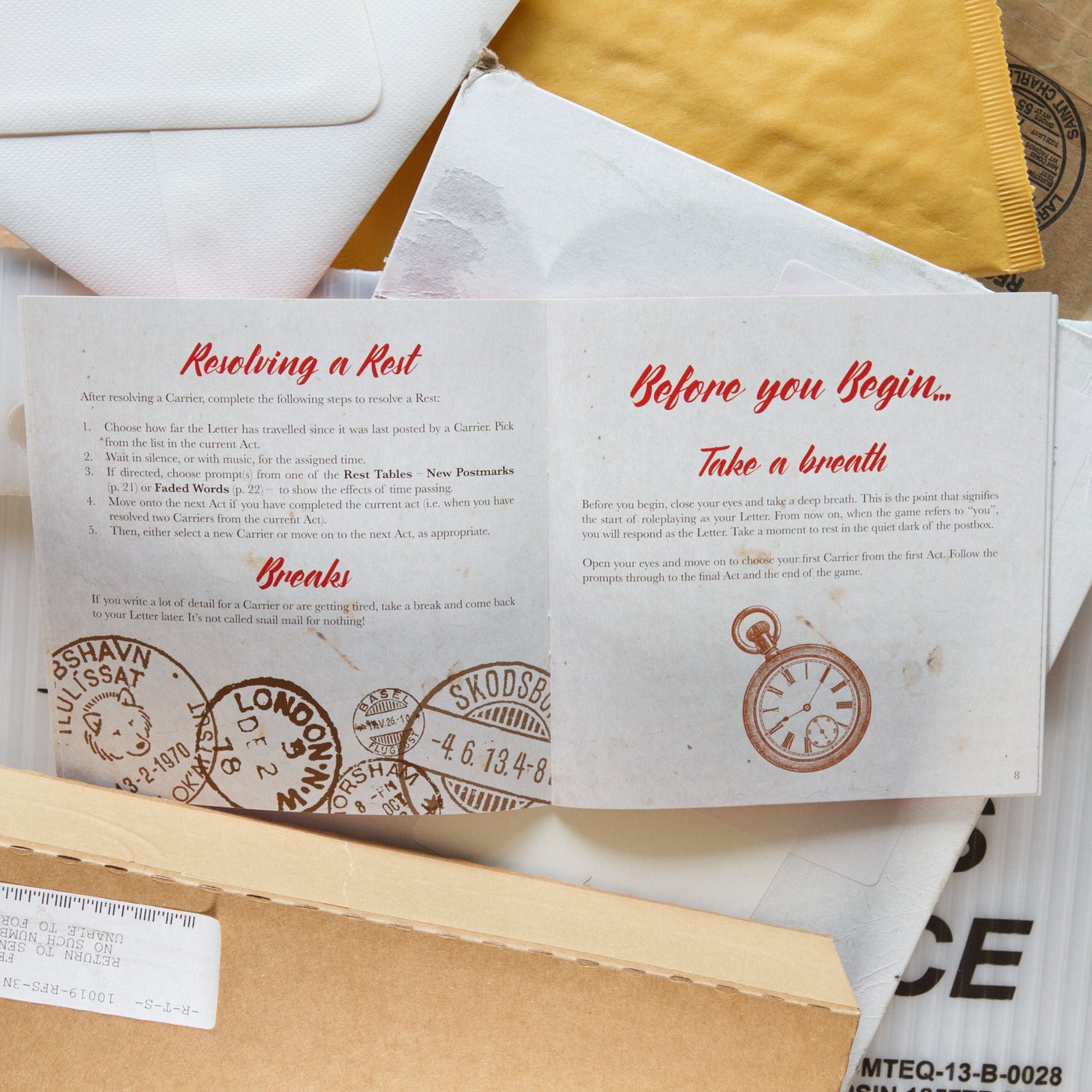 photo of a page spread from lost post  surrounded by postage paraphernalia