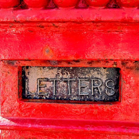 Photographs show a range of red subjects - a notebook cover top left, a close up of a plastic red toy, a faded red post office sign, a red letter box, a red and white rope on a dog toy and a red sign offering home made coffe