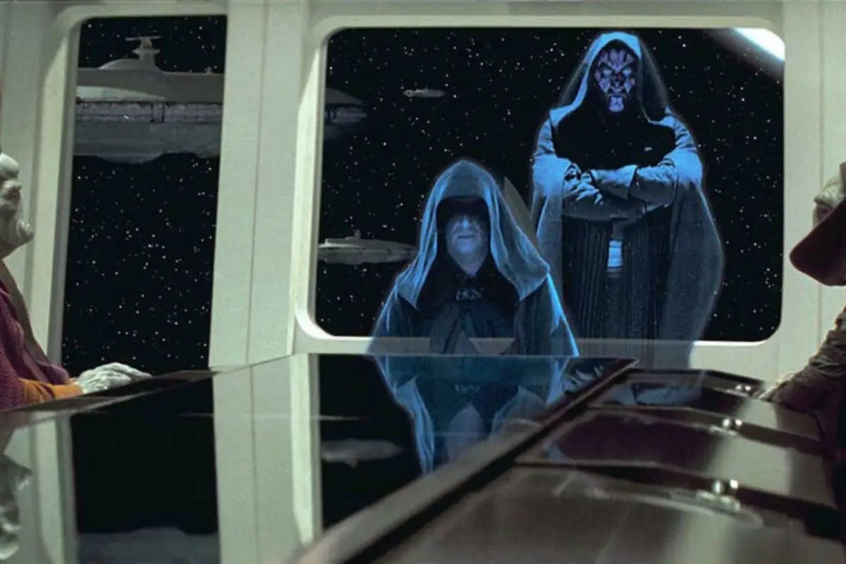 Darth Maul stands behind Darth Sidious, who is addressing Trade Federation officials by hologram.