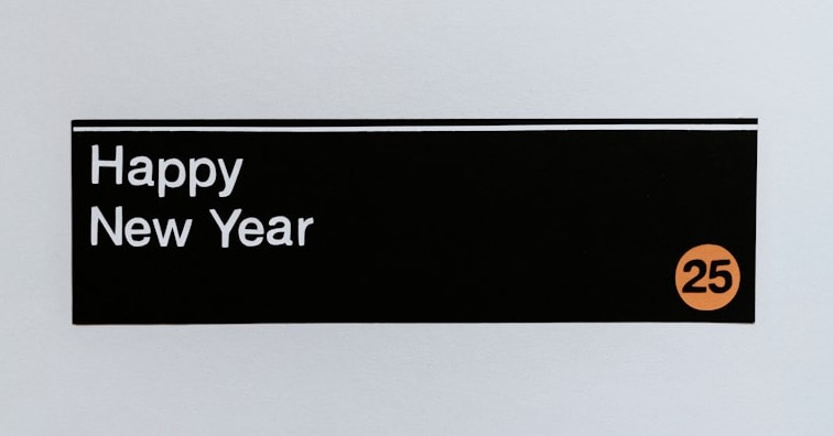 A sign that says happy new year hanging on a wall