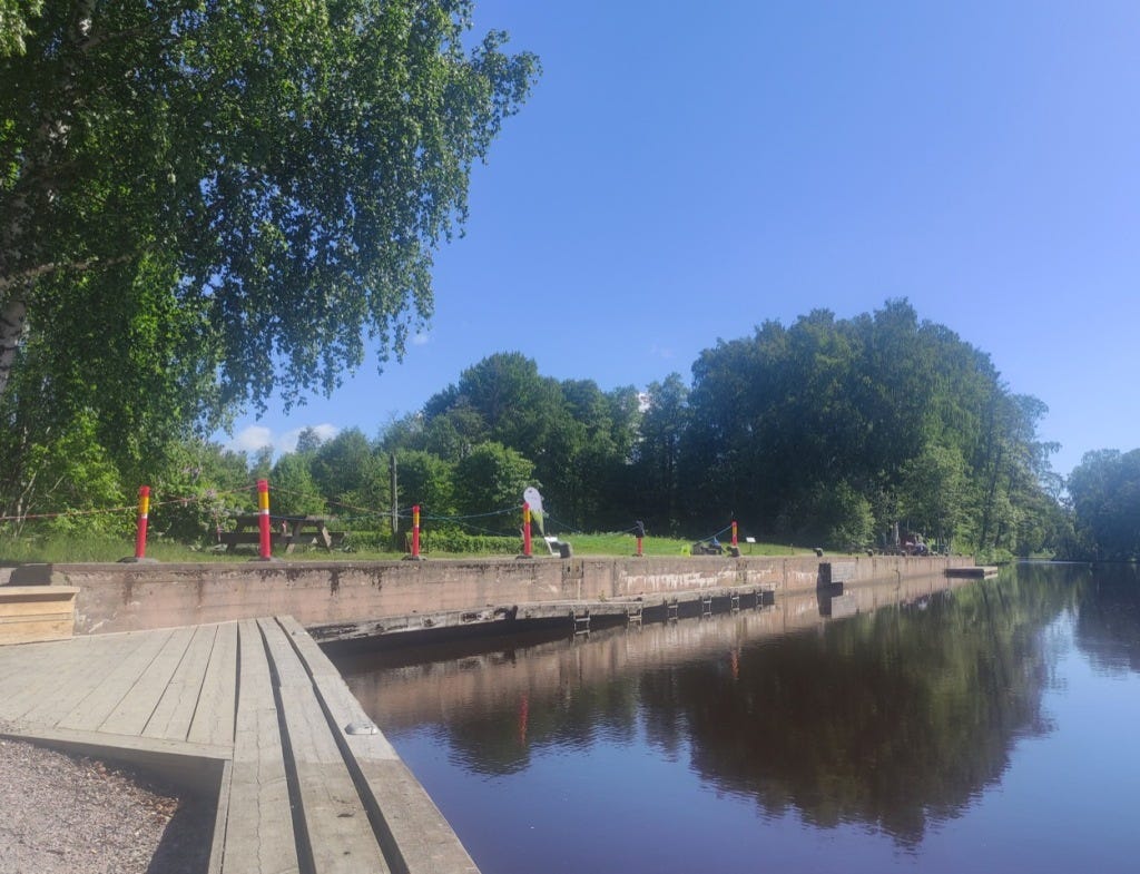 Waterfront view of the finish area, red short poles mark out the finish.