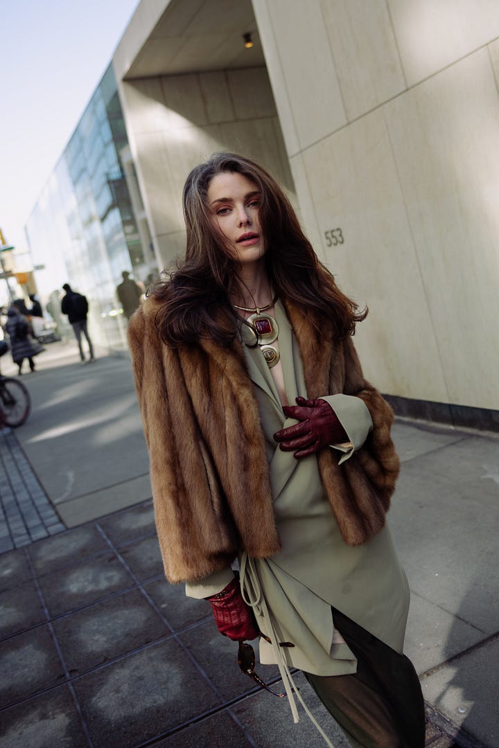 Street style images from NYFW showing Sarah Dewald in a brown fur jacket over a sage green dress with burgundy gloves, and Elsa Hosk in a sculptural white coat and matching hat.