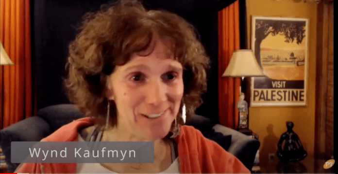 A person smiling at the camera

Description automatically generated