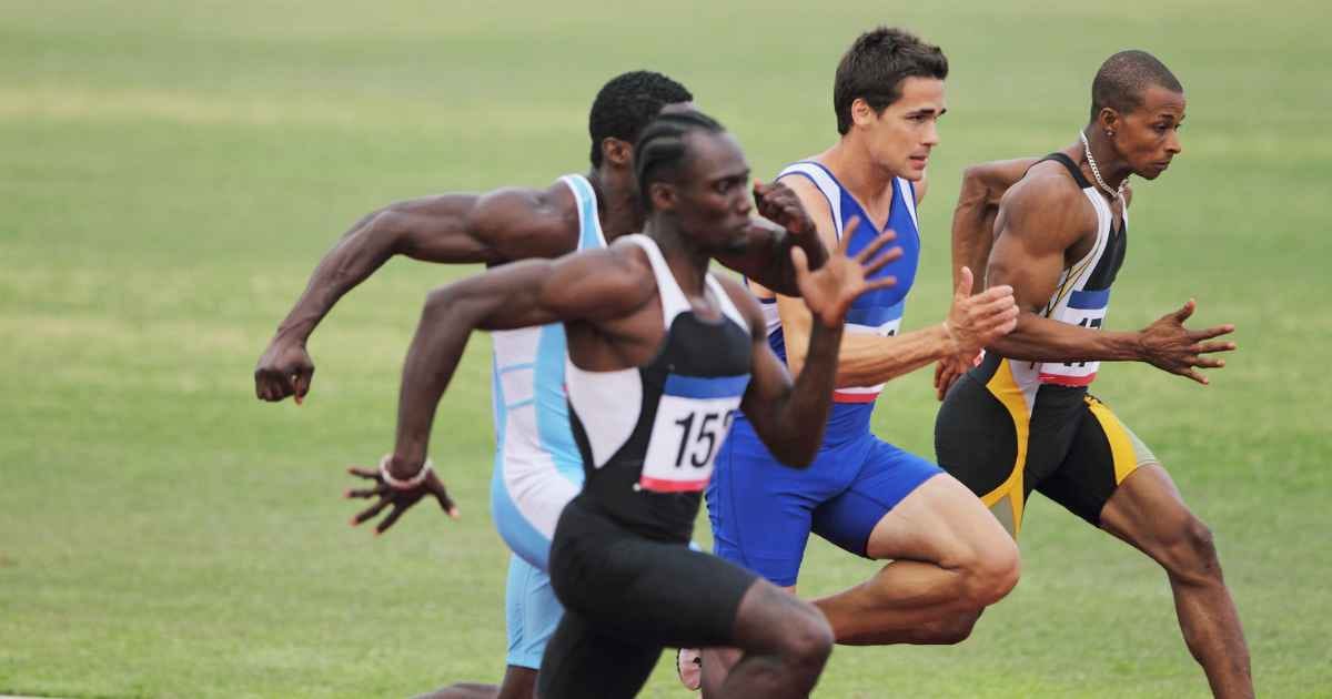 four sprinters racing against each other