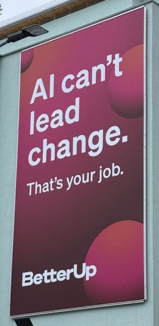 Billboard on side of building saying, "AI Can't Lead Change. That's your job." branded "BetterUp"