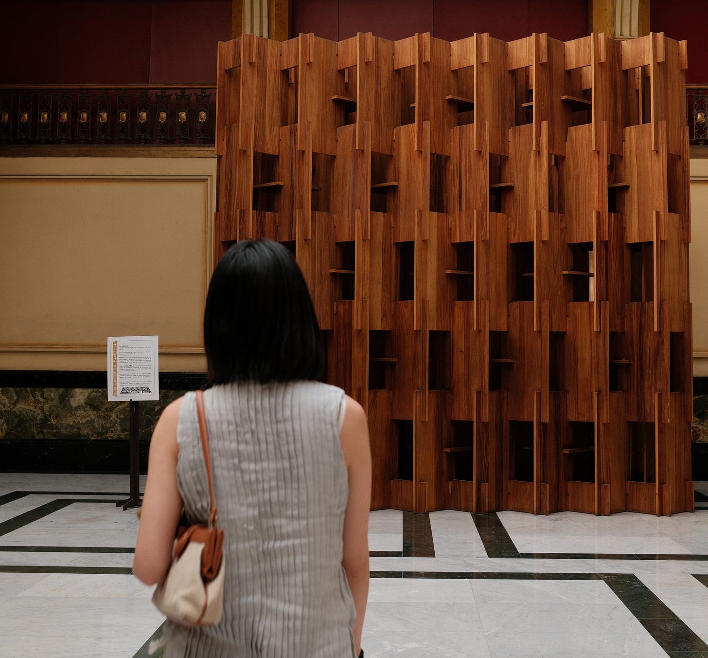 me turned around facing a wooden sculpture