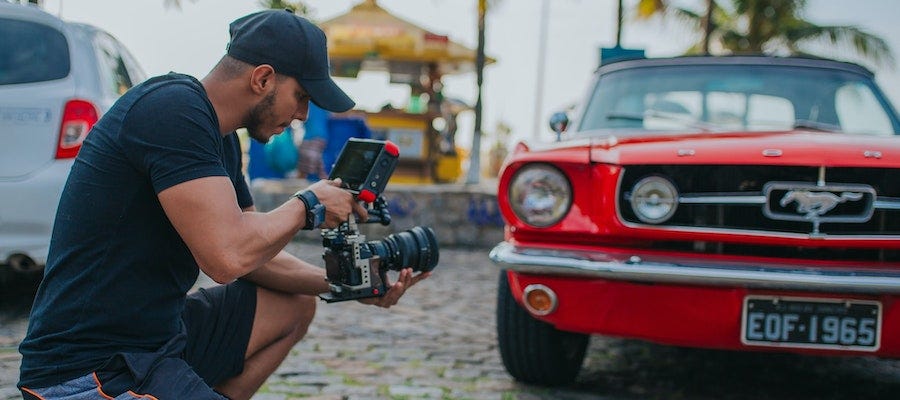 Man recording Ford Mustang
