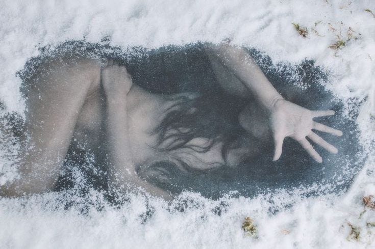 This may contain: a woman is laying in the snow with her arms spread out and hands extended above her head