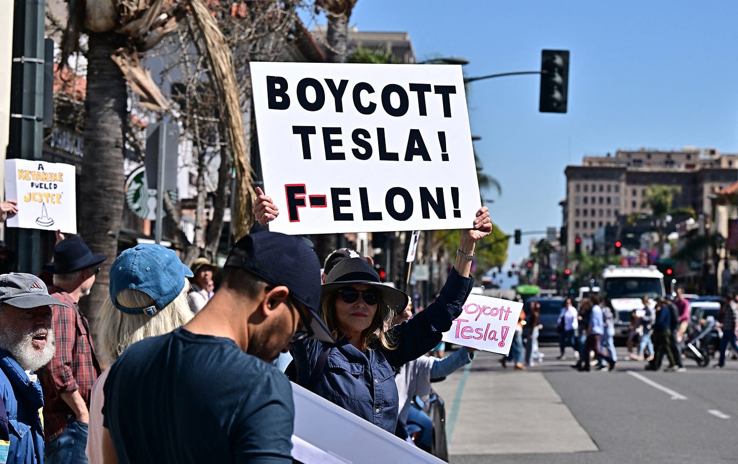 Tesla boycott protest signage