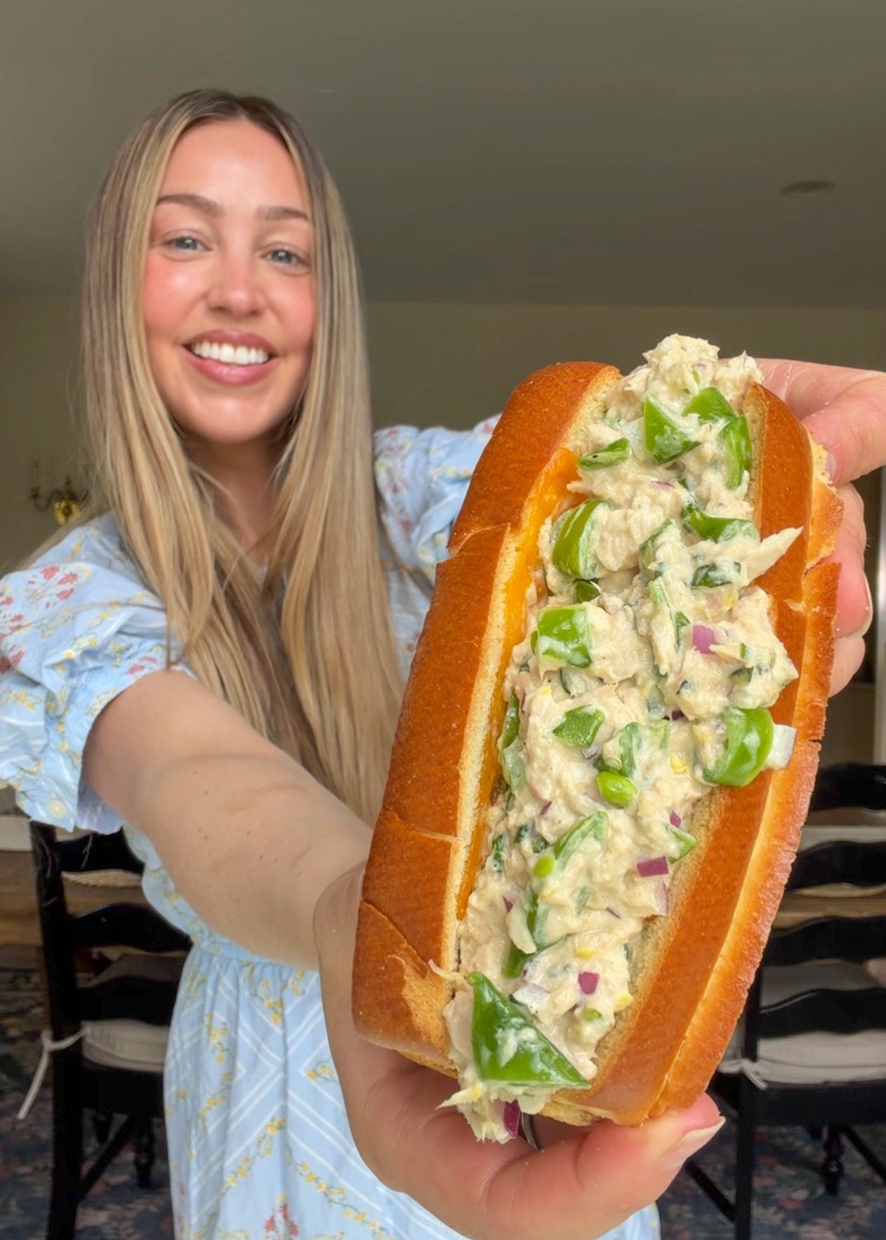 Lemon pepper tuna salad with snap peas served in a toasted brioche bun with cheddar, heirloom tomato, and spicy pickles