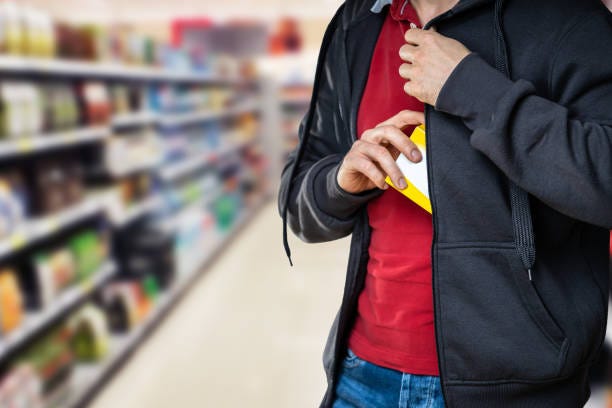 Retail Shoplifting. Man Stealing In Supermarket Retail Shoplifting. Man Stealing In Supermarket. Theft At Shop retailer theft stock pictures, royalty-free photos & images
