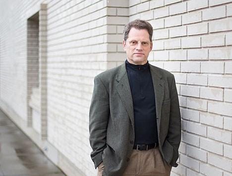 A person standing in front of a brick building

AI-generated content may be incorrect.