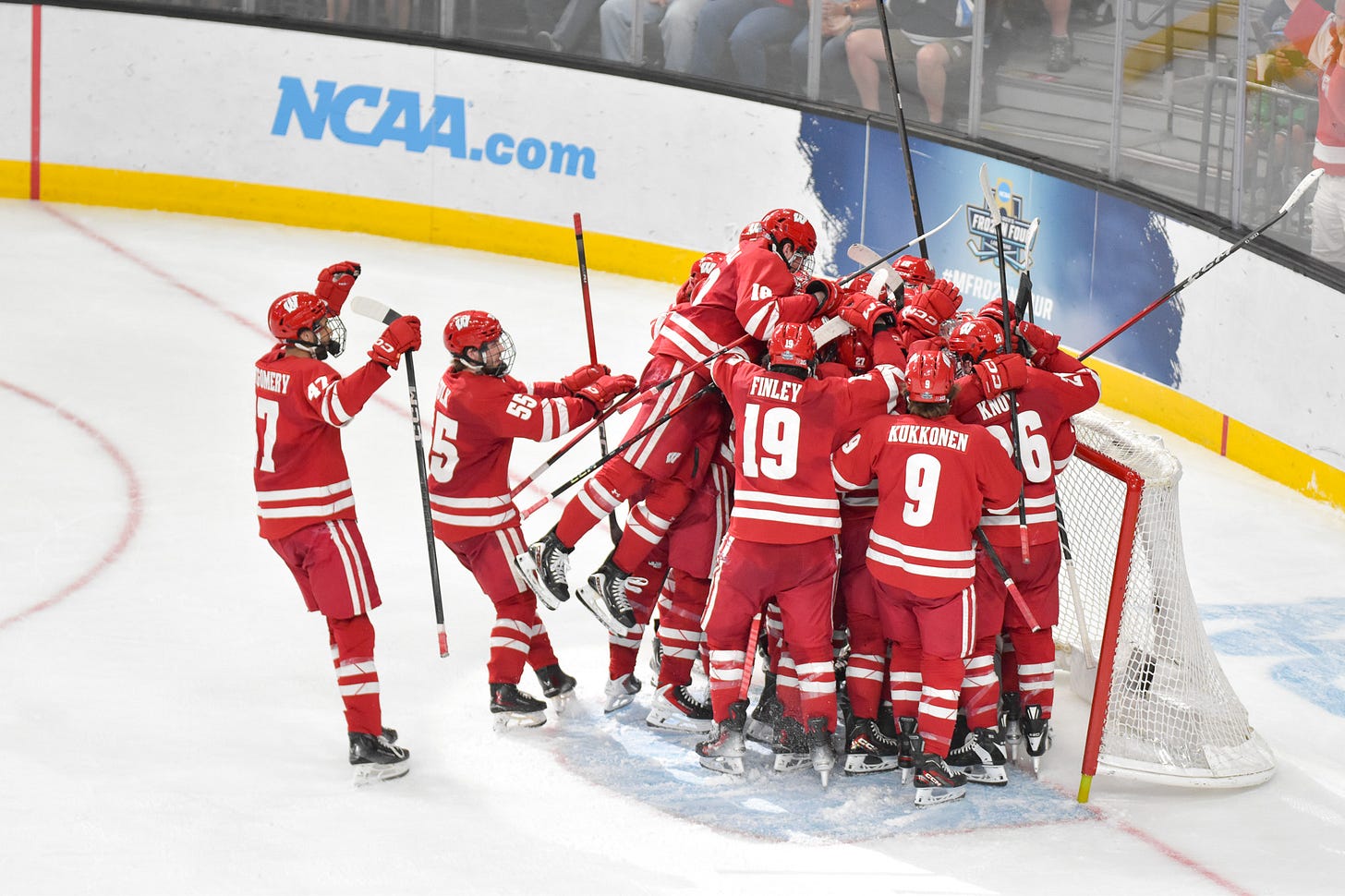 Wisconsin Badgers hockey players push toward the net at the Frozen Four Wisconsin Badgers hockey players push toward the net at the Frozen Four