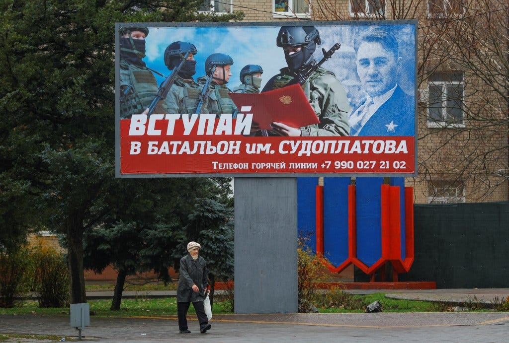 Photo: A local resident walks past a board encouraging to join a Russian army battalion in the course of Russia-Ukraine conflict in Melitopol, Russian-controlled Ukraine, November 27, 2022. A slogan on the board reads: "Join battalion named after Sudoplatov." Credit: REUTERS/Alexander Ermochenko Photo: A local resident walks past a board encouraging to join a Russian army battalion in the course of Russia-Ukraine conflict in Melitopol, Russian-controlled Ukraine, November 27, 2022. A slogan on the board reads: "Join battalion named after Sudoplatov." Credit: REUTERS/Alexander Ermochenko