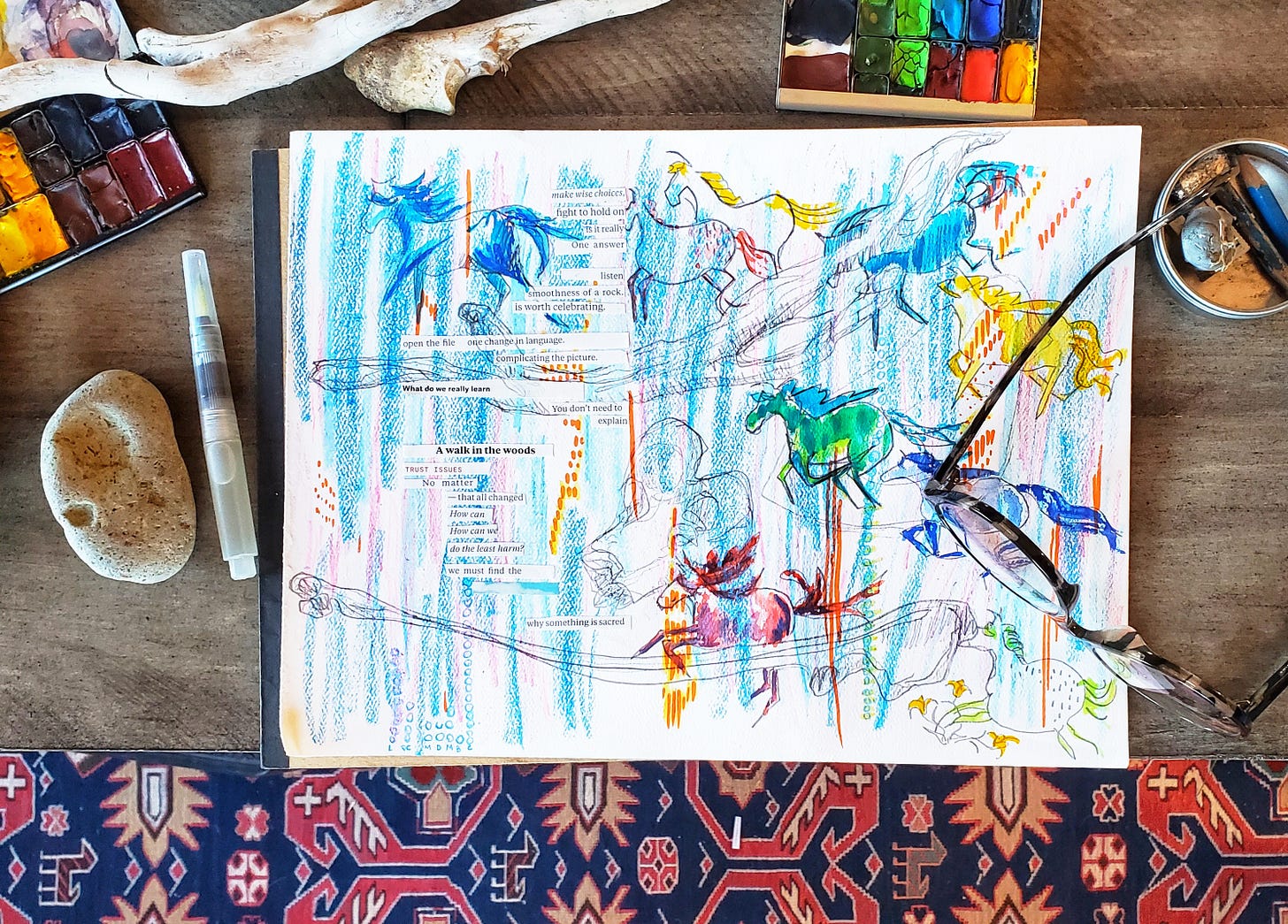 Watercolor paints, a waterbrush pen, bones, sticks, a rock, a pair of glasses, and other art supplies surround a sketchpad. On the sketchpad is a riotously colorful, multi-media artwork that depicts lots of multi-colored horse sketches, bones, sticks, and a poem. The poem is glued on top of the sketch, with each line a separate strip of paper. The lines are all cut out of a magazine, repurposing the prose text into a found poem. The poem reads: make wise choices, fight to hold on is it really  One answer  listen smoothness of a rock. is worth celebrating.   open the file   one change in language.  complicating the picture.  What do we really learn You don’t need to explain. A walk in the woods. TRUST ISSUES. No  matter–that all changed. How can. How can we. do the least harm? we must find the…why something is sacred.