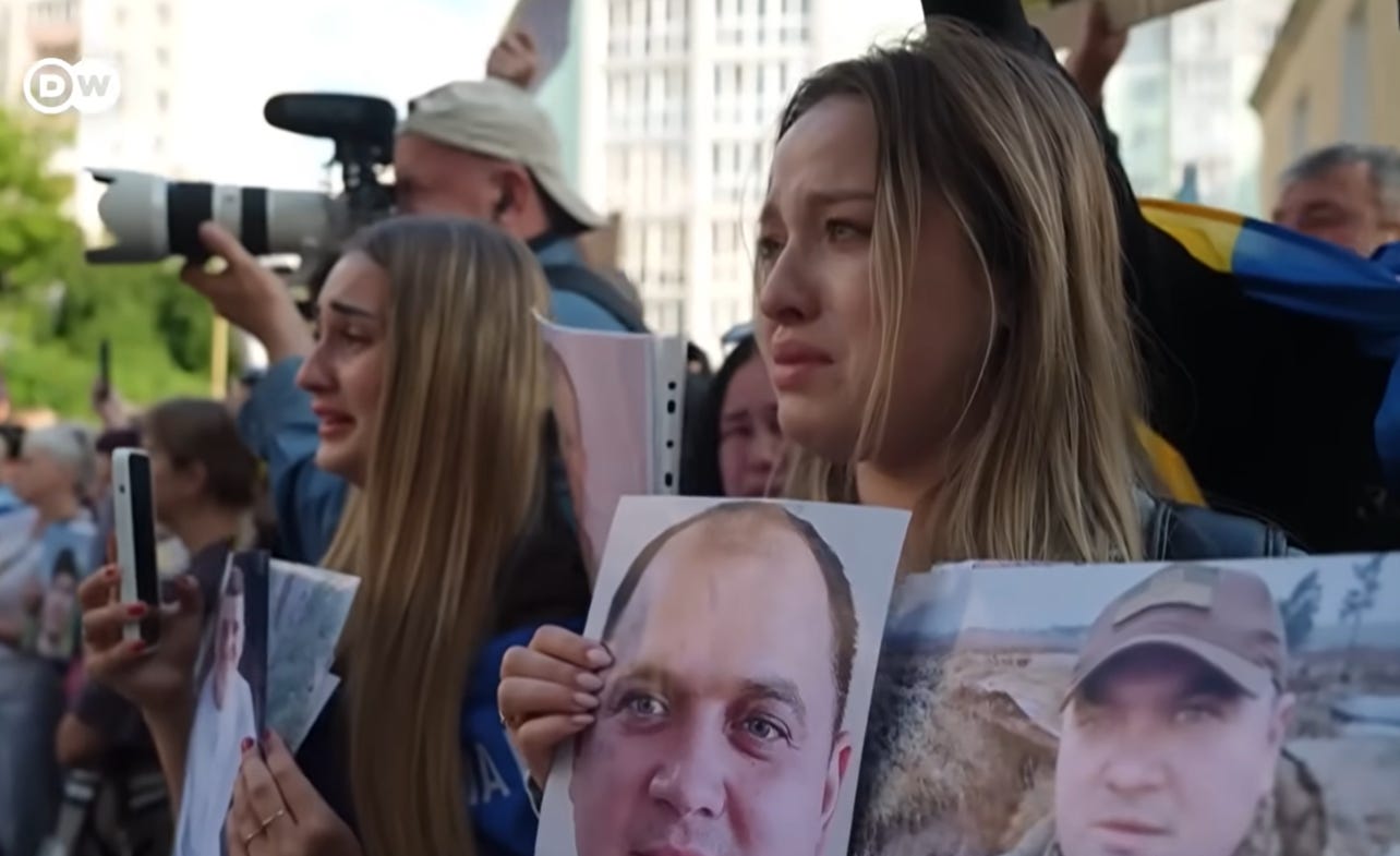 Ukrainian families demonstrate holding photos of missing sons, brothers, fathers