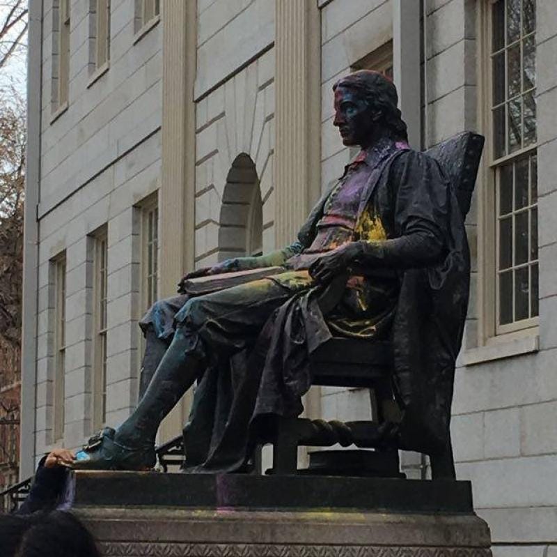 Statue of John Harvard lightly dusted with colored powder Statue of John Harvard lightly dusted with colored powder