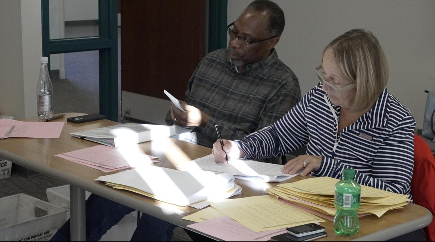 Two members of the Ingham County Board of Canvassers in Michigan reviewing election records. Two members of the Ingham County Board of Canvassers in Michigan reviewing election records.