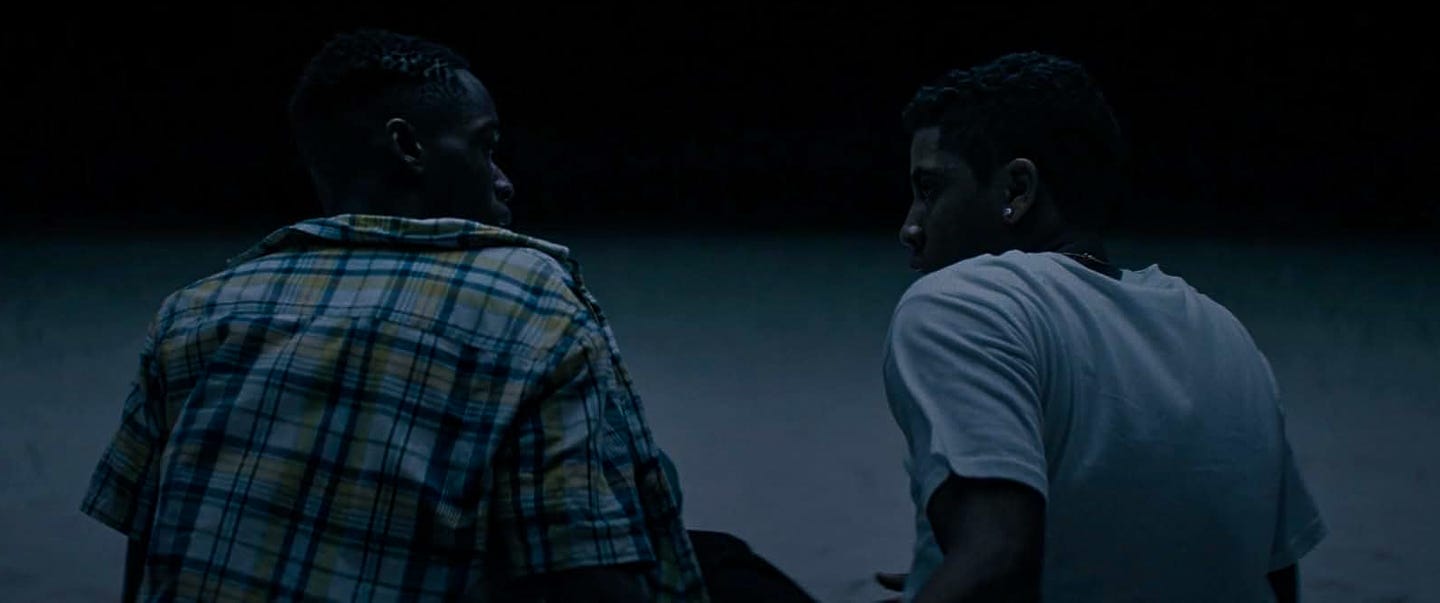 Chiron and Kevin sit together on the moonlit beach, their shoulders turned toward each other as silence speaks volumes between them. Chiron and Kevin sit together on the moonlit beach, their shoulders turned toward each other as silence speaks volumes between them.