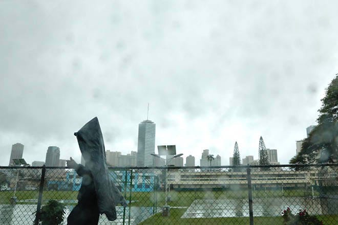 JAMM AQUINO / JAQUINO@STARADVERTISER.COM
                                A pedestrian with a garbage bag as a raincoat walks in the rain along South King Street today as heavy rain from a passing storm continue to move east over Oahu and across the state.