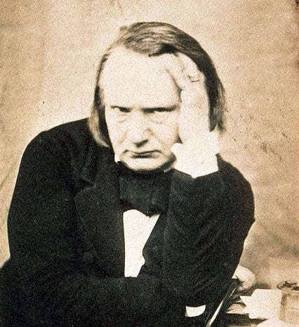 Young Victor Hugo with his hand on his head.