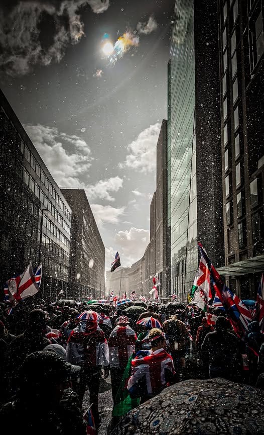 May be an image of 1 person, street and crowd May be an image of 1 person, street and crowd