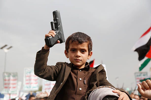 Yemeni child sits on the shoulder of his father as they take part in a protest staged against the Israeli continued war and blockade on the people in...