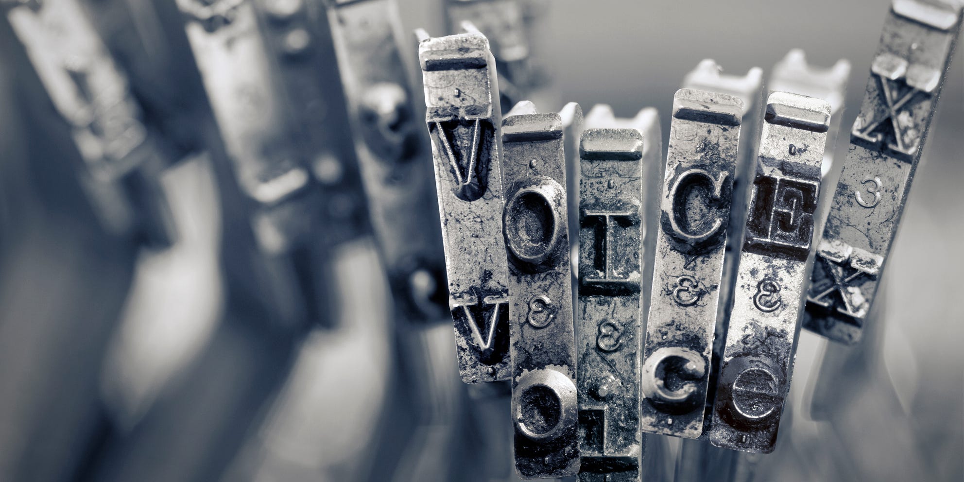 Typewriter keys spelling out "Voice" representing writing voice.