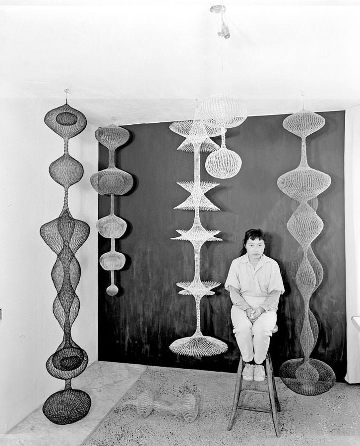 Ruth with her looped-wire sculptures, c. 1956.
Photo by Paul Hassel