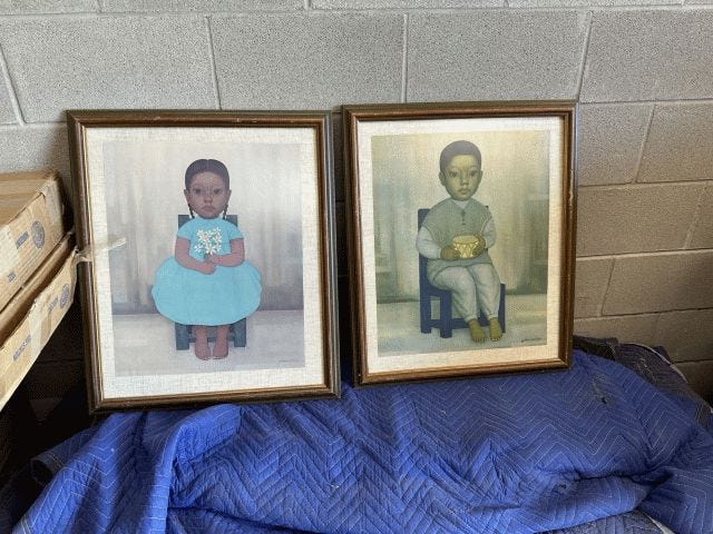 Side-by-side framed paintings of a little girl and little boy