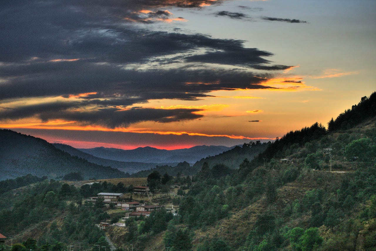 picture of a sunset over a small town in valley