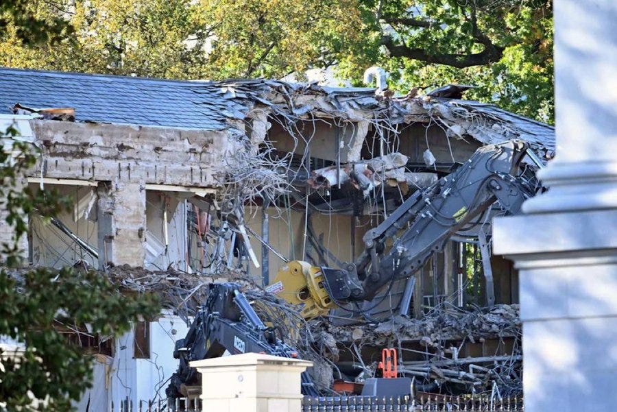 A backhoe tears down the East Wing of the White House. Of course the work is being done by non-union labor