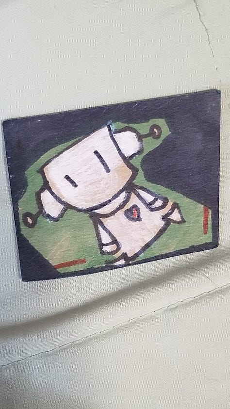a cartoon robot drawn and painted on many surfaces.