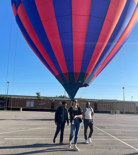 Linea driving and giving a peace sign, Linea presenting on a stage, Linea and her dad smiling and wearing sunglasses, the Northern Lights, Linea making a scared face next to her smiling dad at The House on the Rock, Linea and two friends in front of a hot air balloon.
