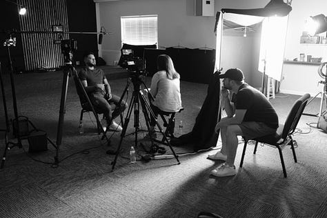 9 photos from the interview day with David. Photos feature Claire, Murray, Garrett, Jody, & David on set in the church sanctuary.