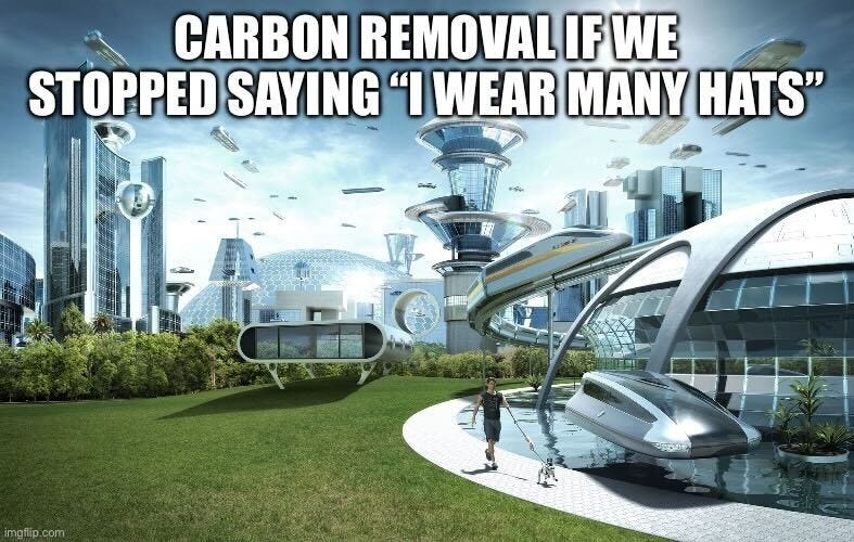 "Carbon removal if we stopped saying 'I wear many hats'" above a gleaming futuristic city with monorails and glass towers.