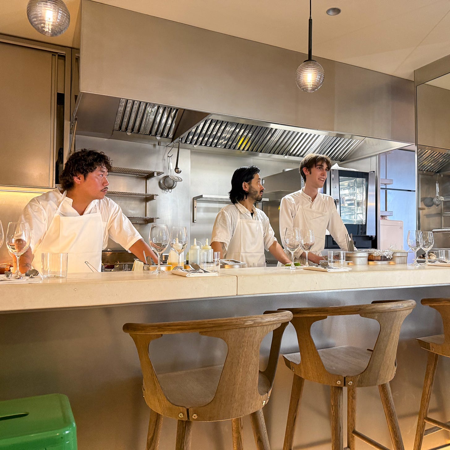Cooks at the open kitchen counter with bar seating at Petit Vatel, Paris 6th Cooks at the open kitchen counter with bar seating at Petit Vatel, Paris 6th