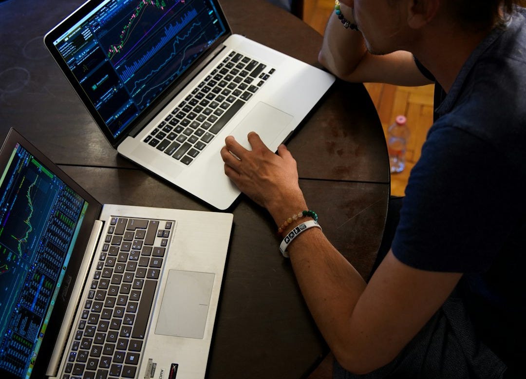 man sitting in front of the MacBook Pro