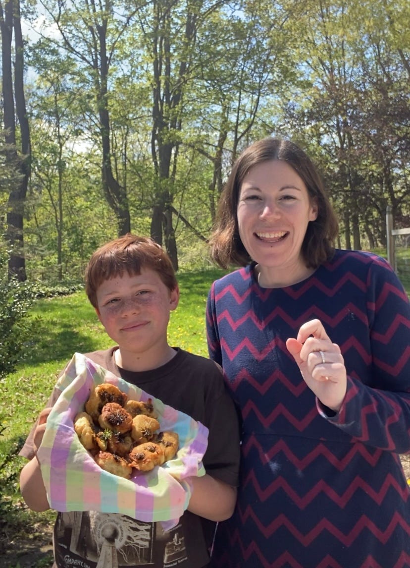 Mom and son who is holding a basket of homemade fritters, standing outside