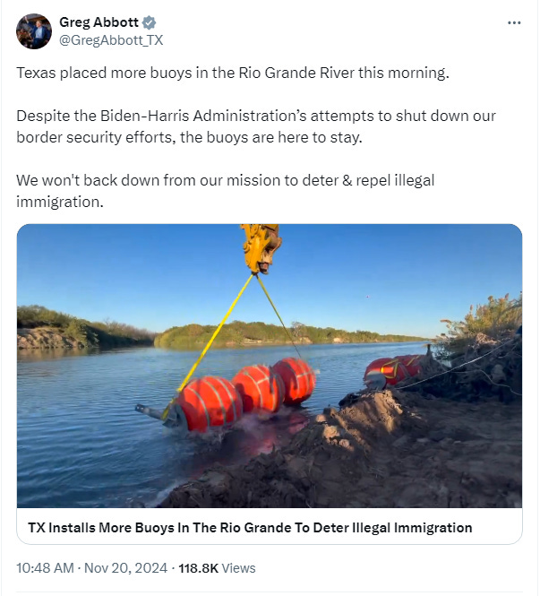 Screenshot of tweet by Greg Abbott: 'Texas placed more buoys in the Rio Grande River this morning.  Despite the Biden-Harris Administration’s attempts to shut down our border security efforts, the buoys are here to stay.  We won't back down from our mission to deter & repel illegal immigration.'  Image: video of a large crane lifing a string of three large buoys from a flatbed truck and dropping them into the river for assembly with others. 