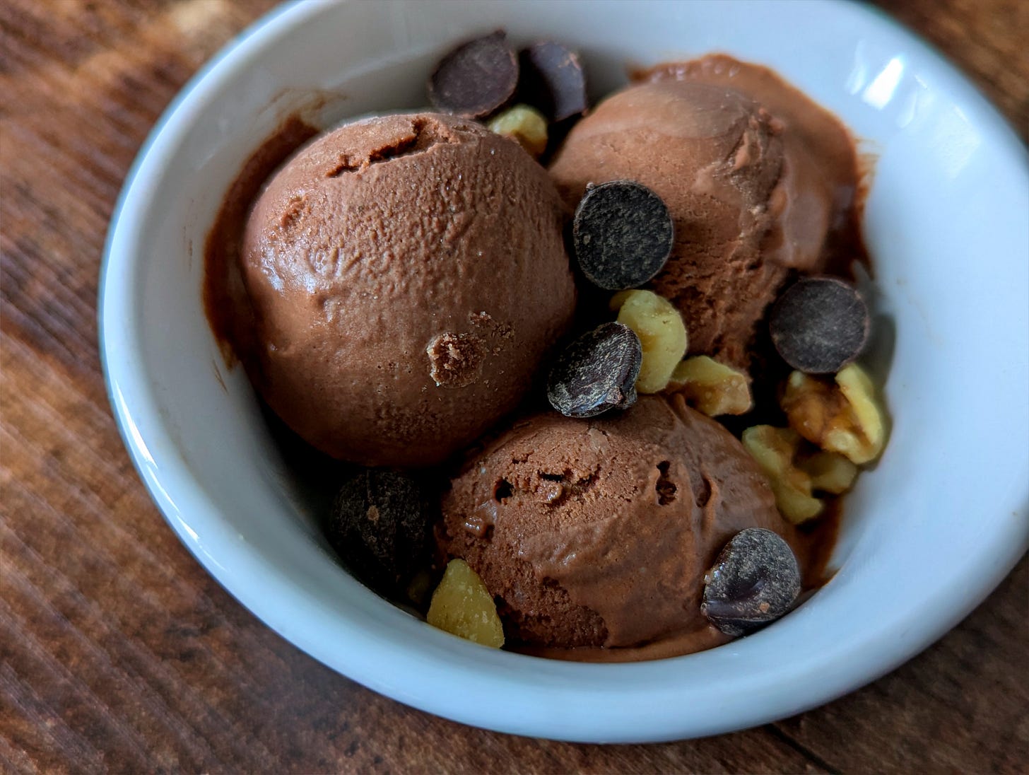 Ice cream with chocolate chips and walnuts in a bowl. 