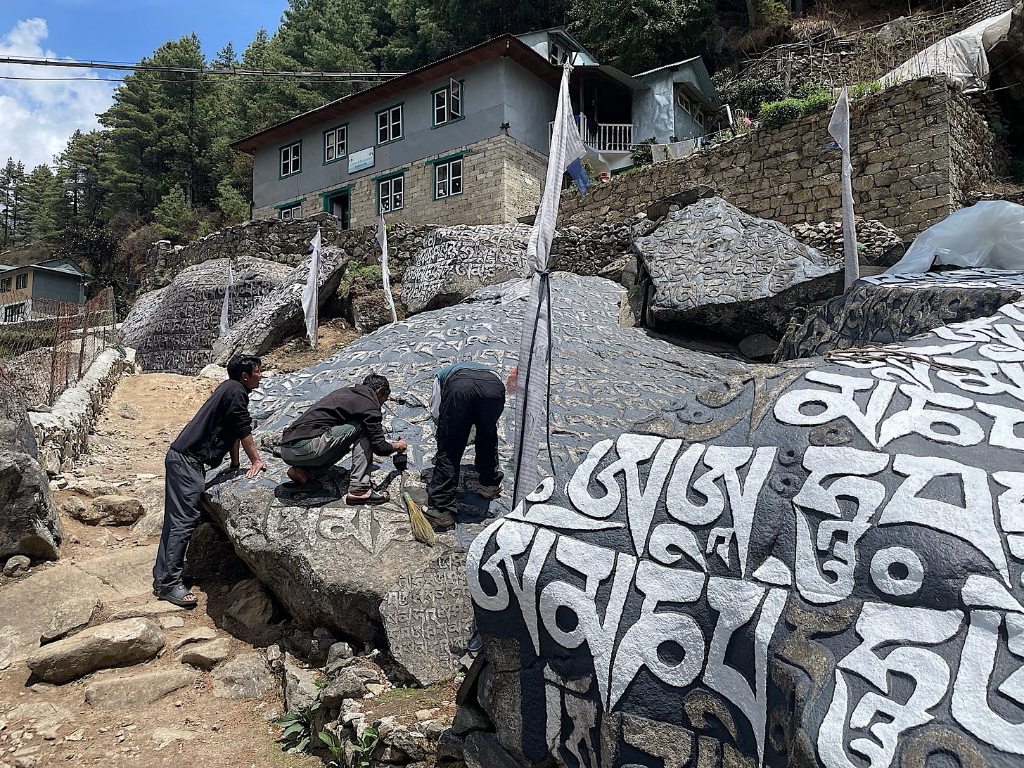 These monks were painting the mantra stone just outside the lodge. They were just finishing it up when we returned over a week later.