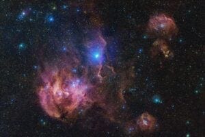 The Running Chicken Nebula comprises several clouds, all of which we can see in this vast image from the VLT Survey Telescope (VST), hosted at ESO’s Paranal site. This 1.5-billion pixel image spans an area in the sky of about 25 full Moons. The clouds shown in wispy pink plumes are full of gas and dust, illuminated by the young and hot stars within them.
