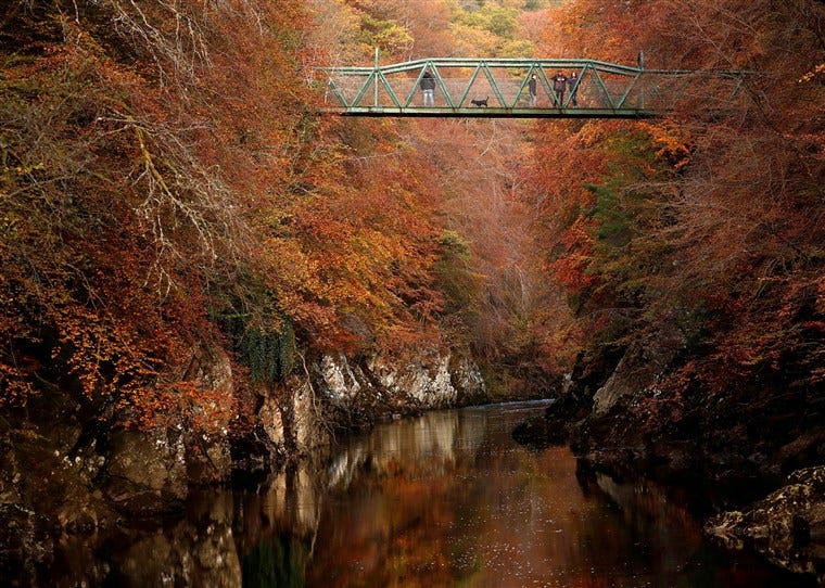 Image: People walk on the bridge over the river Garry, Pitlochry, Scotland Image: People walk on the bridge over the river Garry, Pitlochry, Scotland