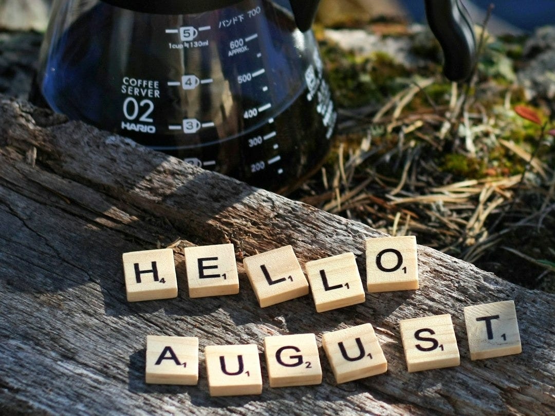 a coffee pot with scrabbles spelling hello august