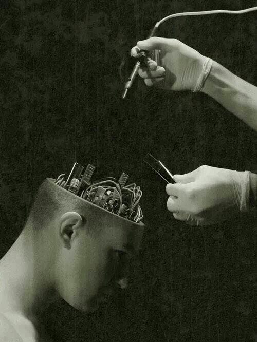 This may contain: two people with cell phones on their heads, one holding scissors and the other looking at an electronic device