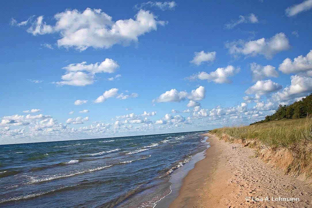Lake Michigan with popcorn clouds overhead and a slanted horizon