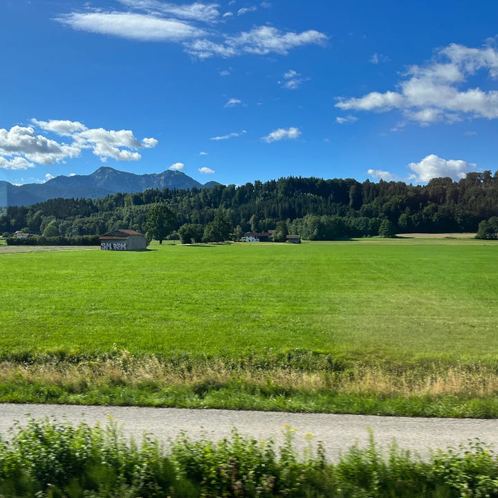 Photos taken out of a train carriage looking at summer Bavarian landscape