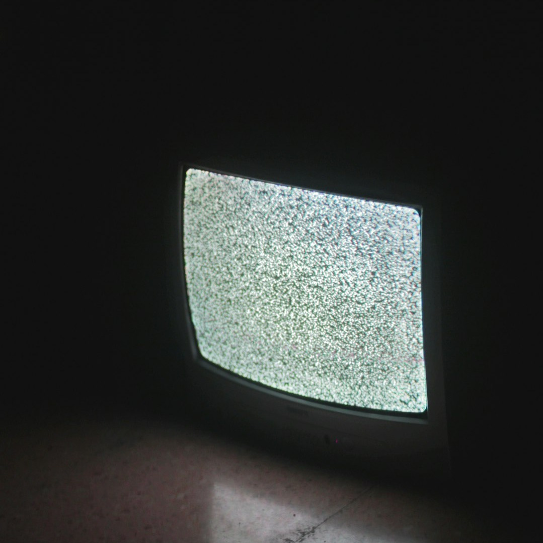 gray crt tv turned on in a dark room gray crt tv turned on in a dark room